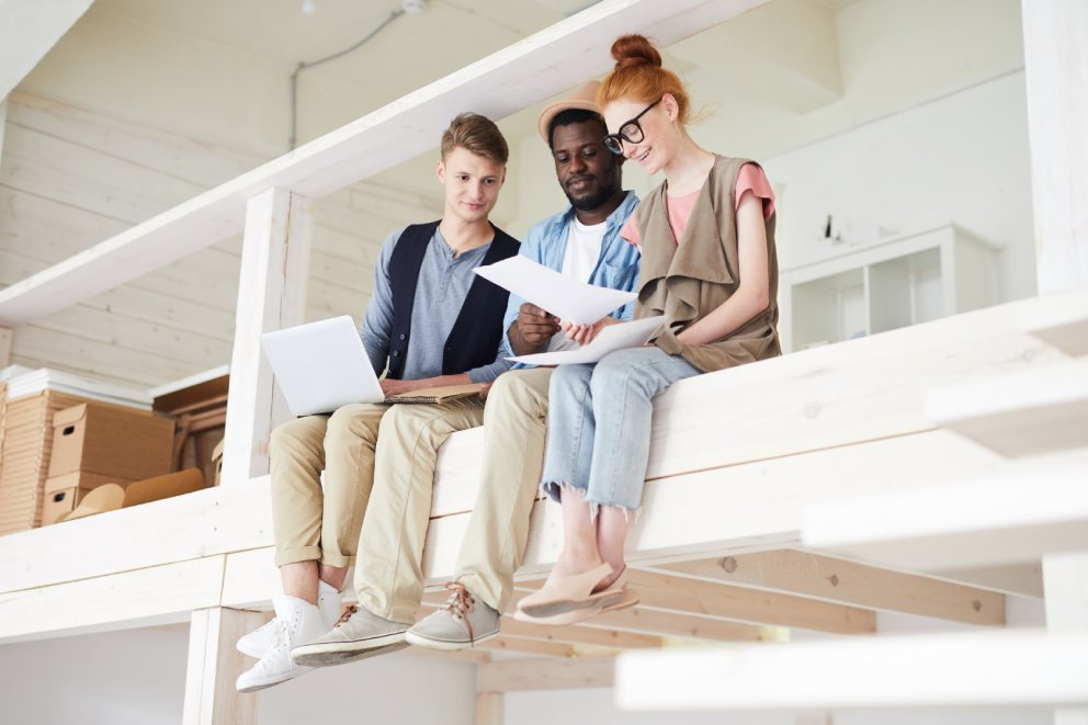 Three young people working on a startup